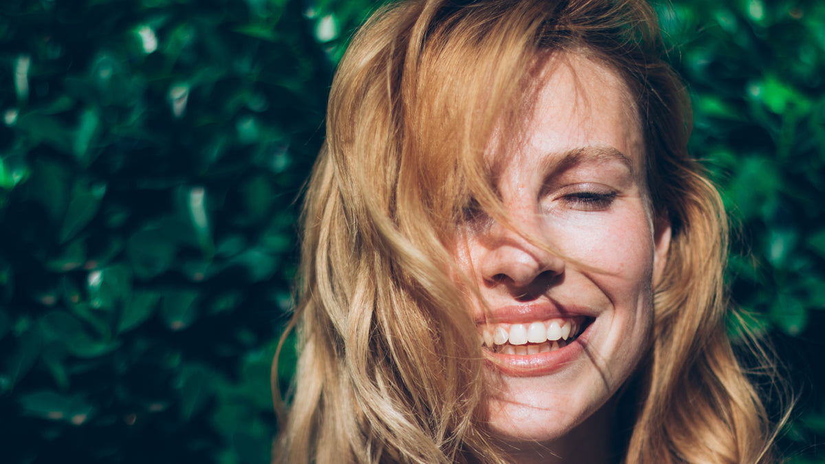 blonde white girl laughing eyes closed outside