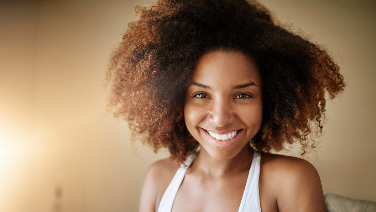 young black woman smiling with great skin