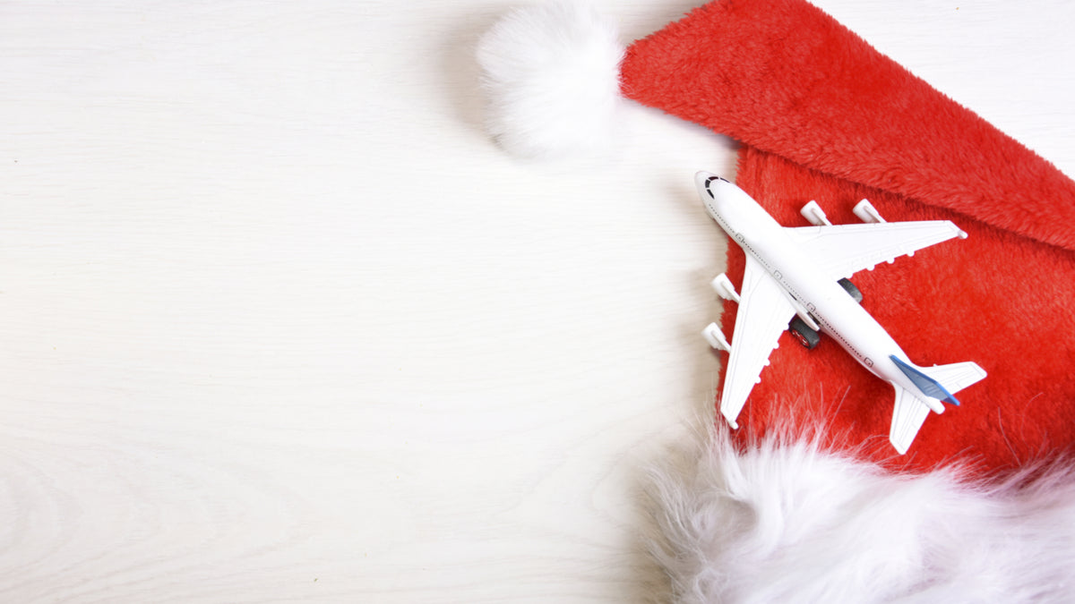 santa hat with toy airplane on white background
