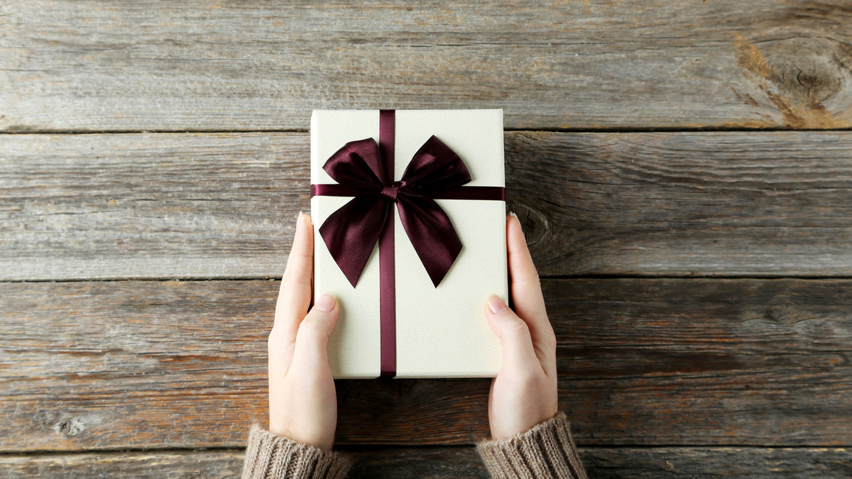 wrapped gift with bow on a wooden table