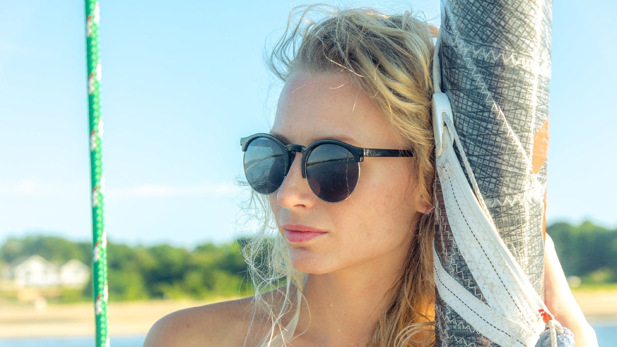 young blonde woman in the sunshine wearing sunglasses