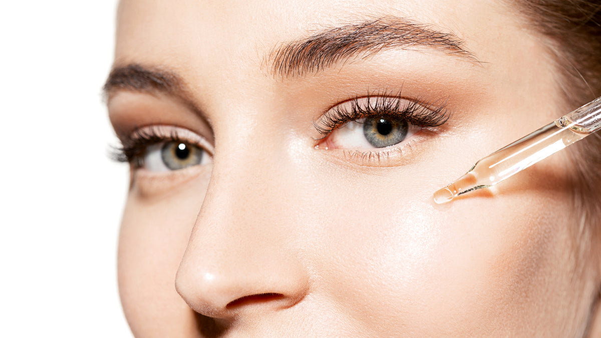 close-up of white woman with beautiful skin applying serum