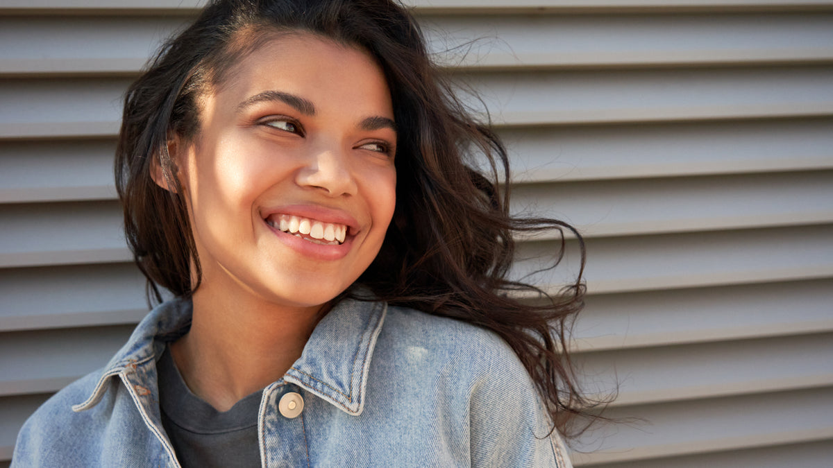 beautiful girl smiling and showing off great skin