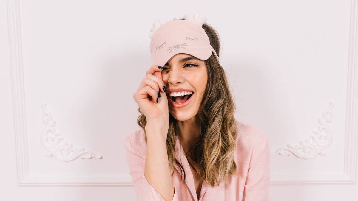 white girl laughing with sleep mask on head