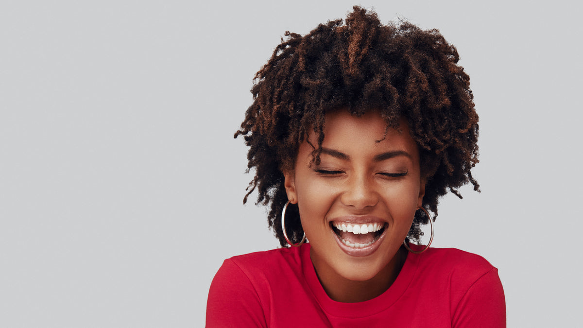 beautiful black woman with great skin smiling with eyes closed