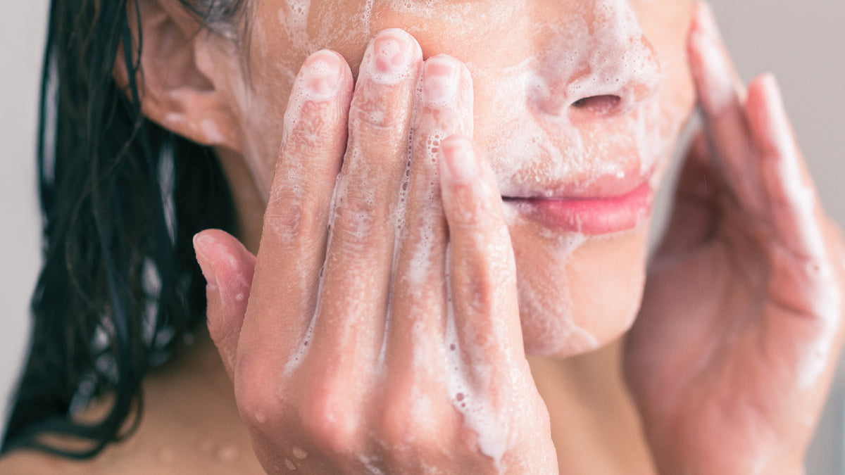 close-up of white brunette girl cleansing face