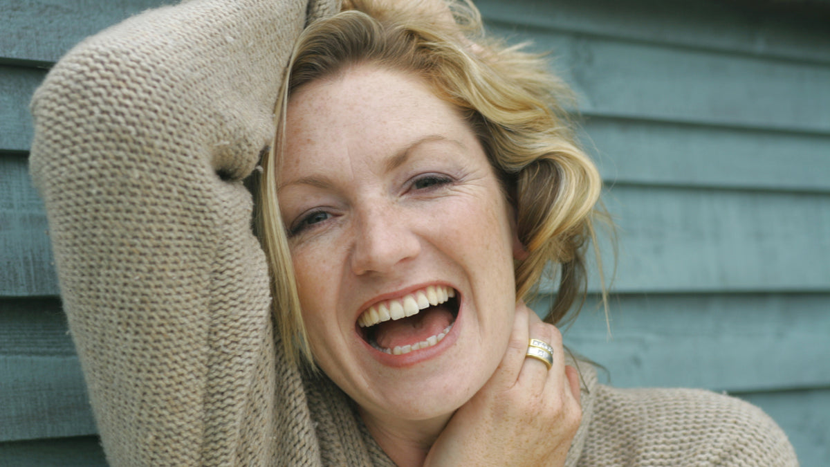 mature woman laughing outside great skin