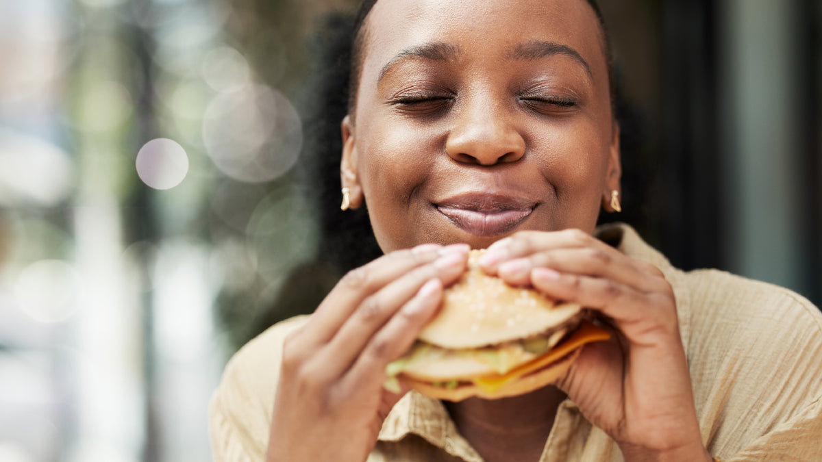 young black woman eating a burger