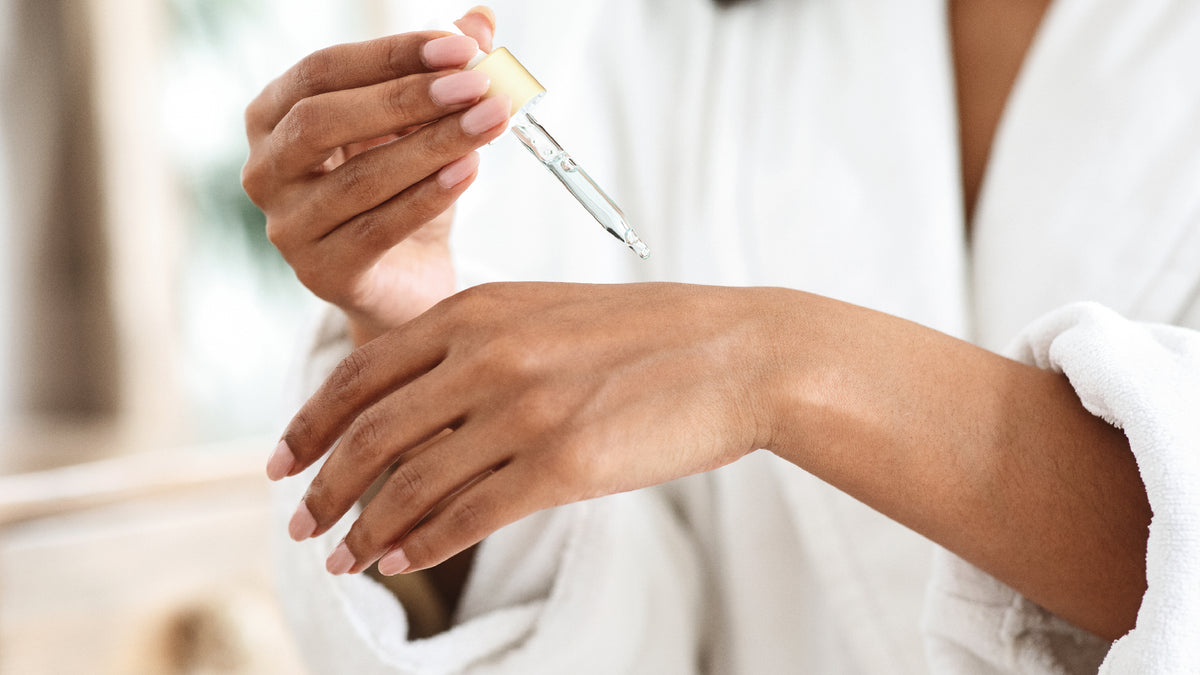 close-up of face serum being applied to back of hand