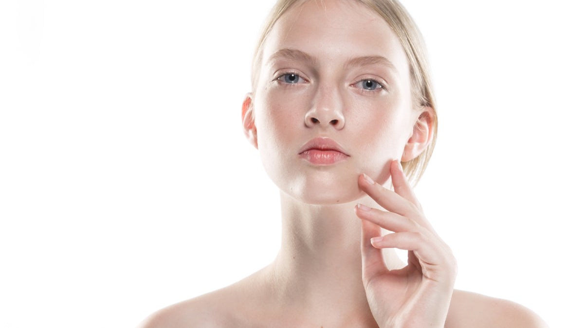 young blonde woman with amazing skin on white background