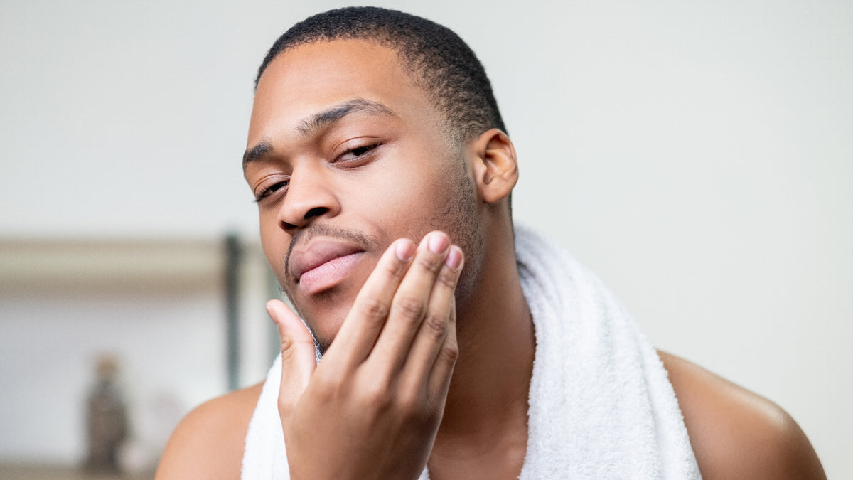 man checking out shaving skin in mirror