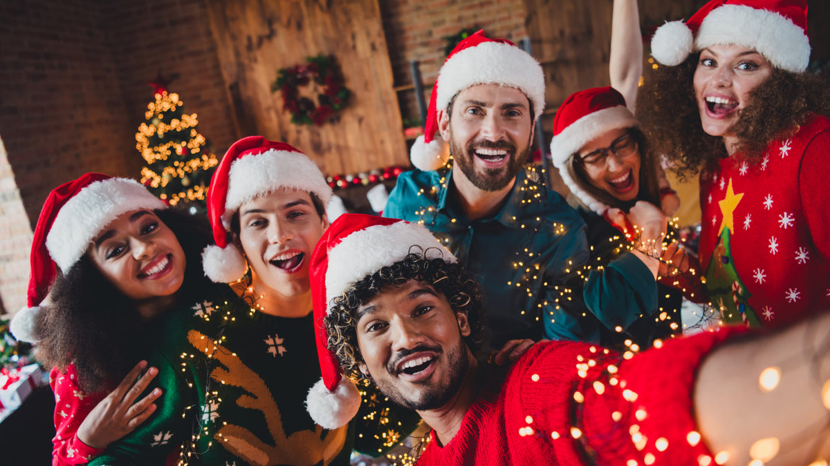 bunch of friends in santa hats taking selfie