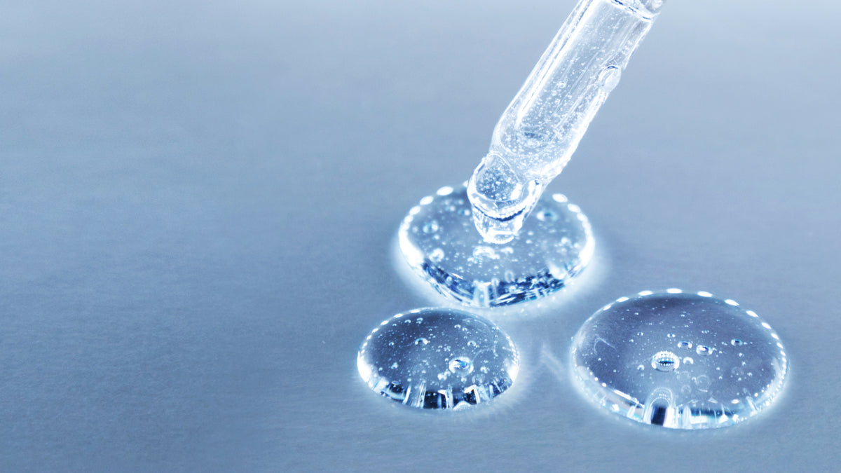 pipette with serum on blue backgroun