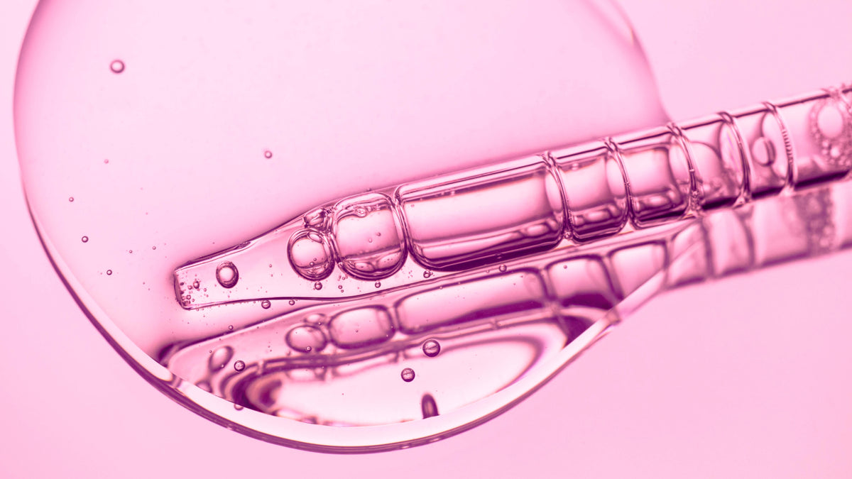 serum and pipette on pink background