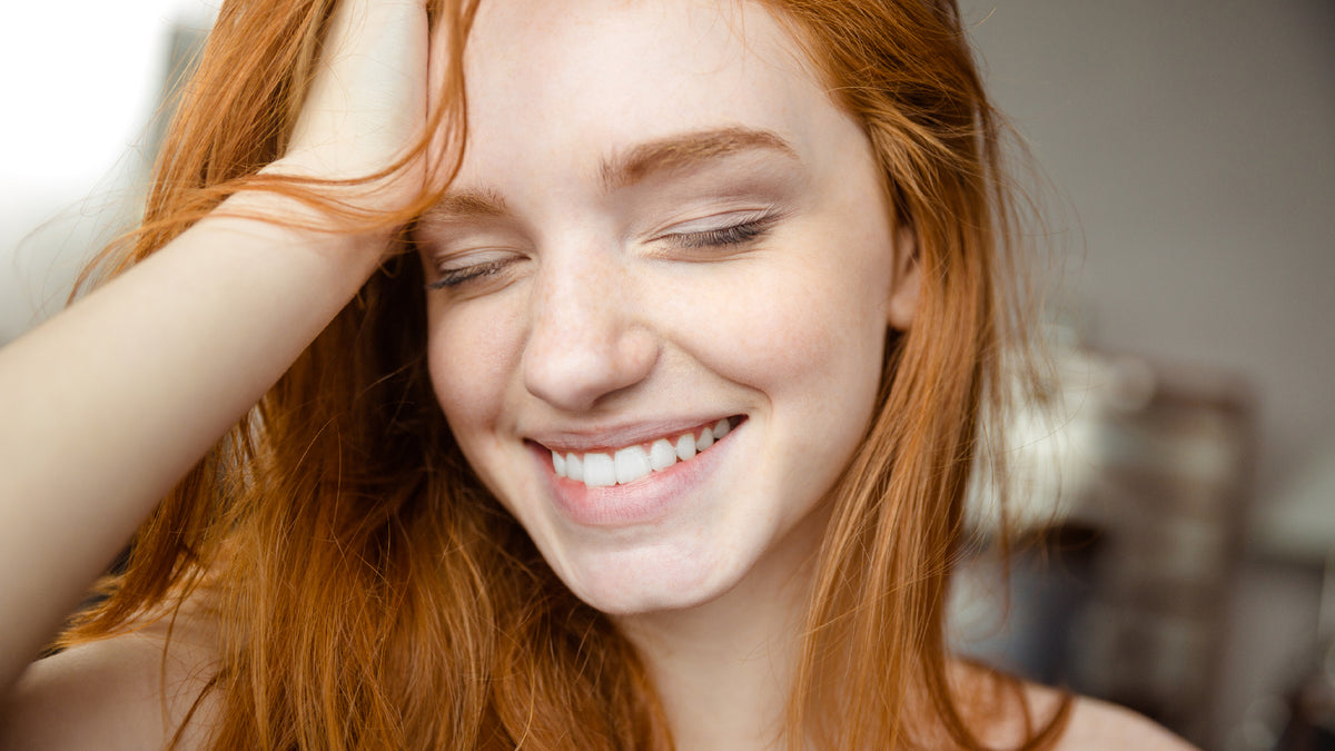 beautiful redhead smiling with eyes closed