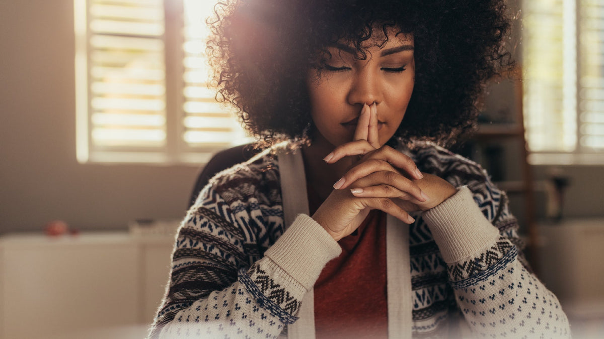 young black woman with eye closed thinking