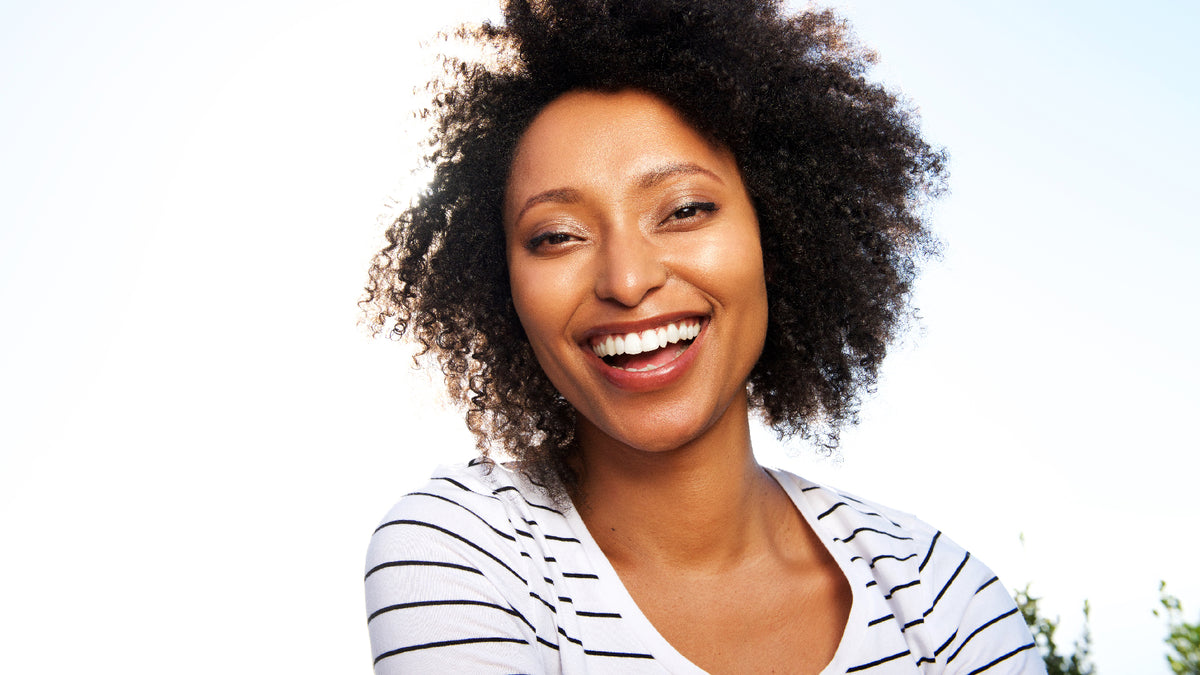 young black woman smiling outside 