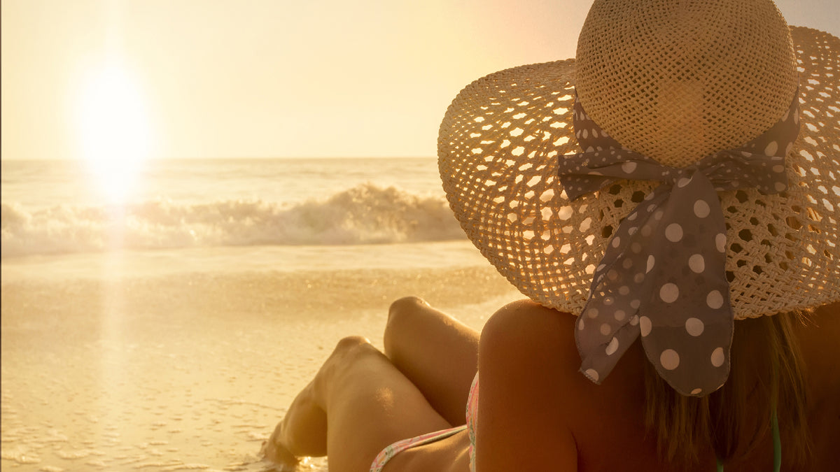 woman lying on beach at sunset