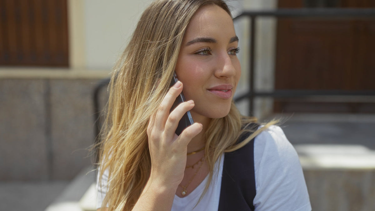 young blonde woman on cell phone outside 